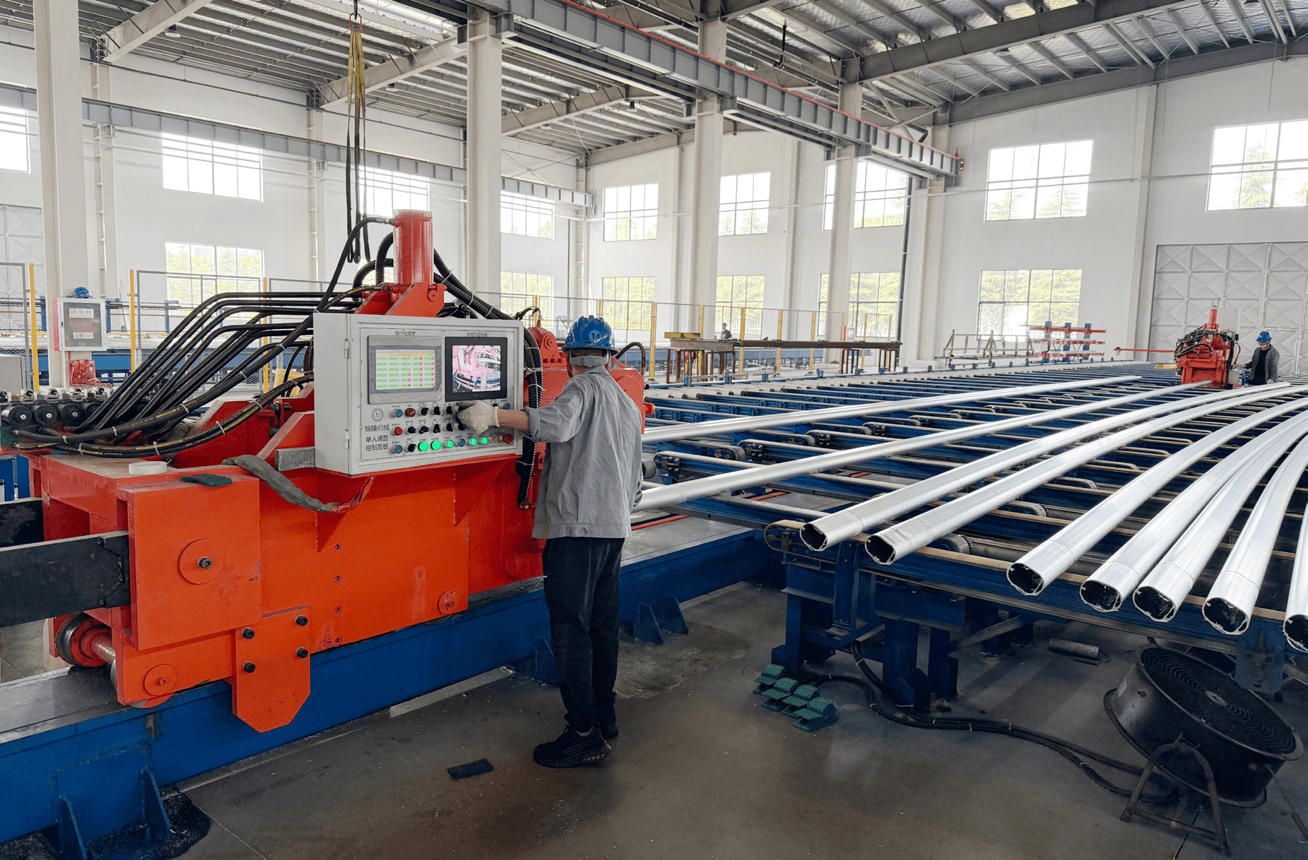Worker operating aluminum tube bending machine